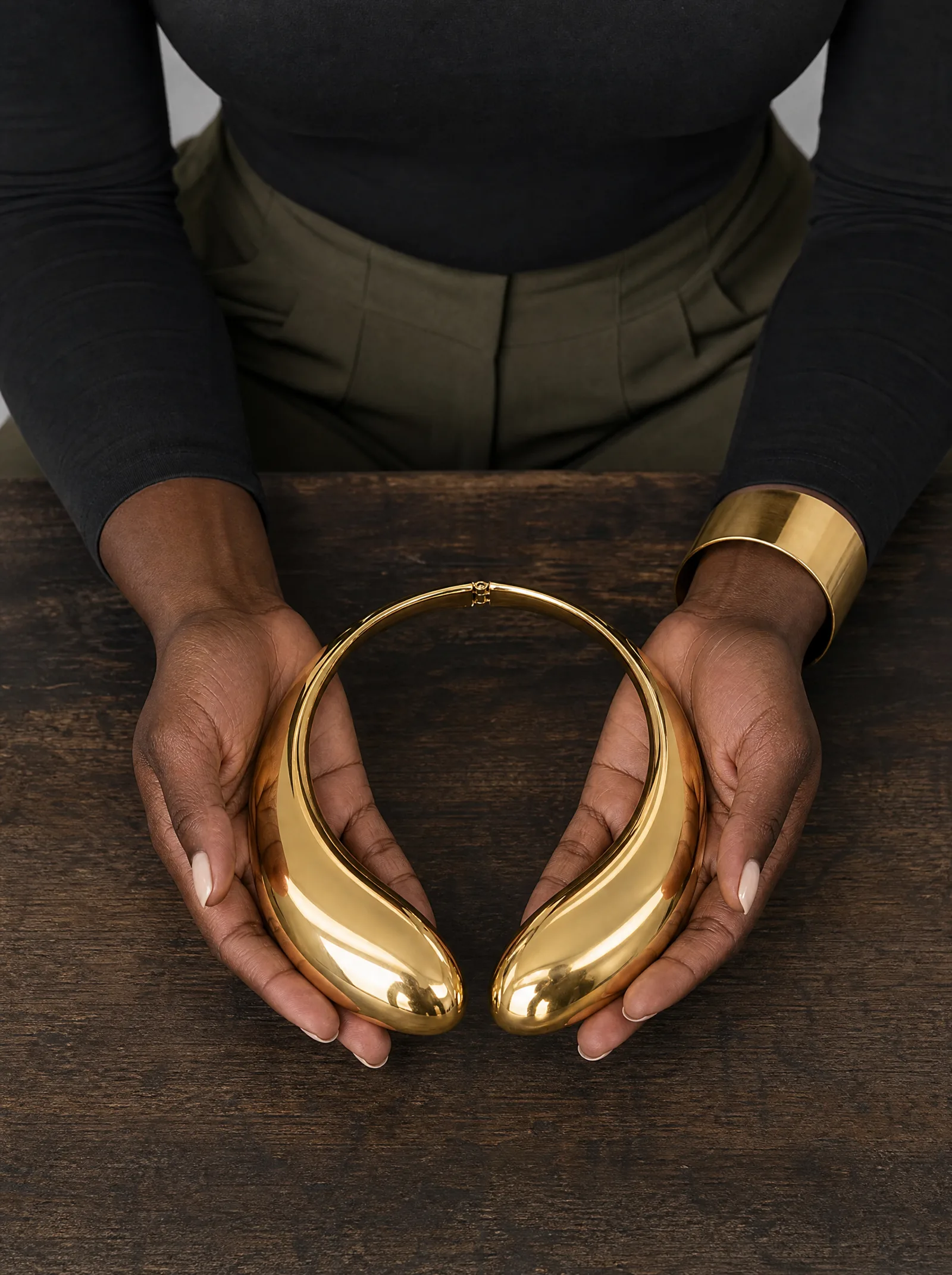Zuri wearing a statement necklace in a studio portrait